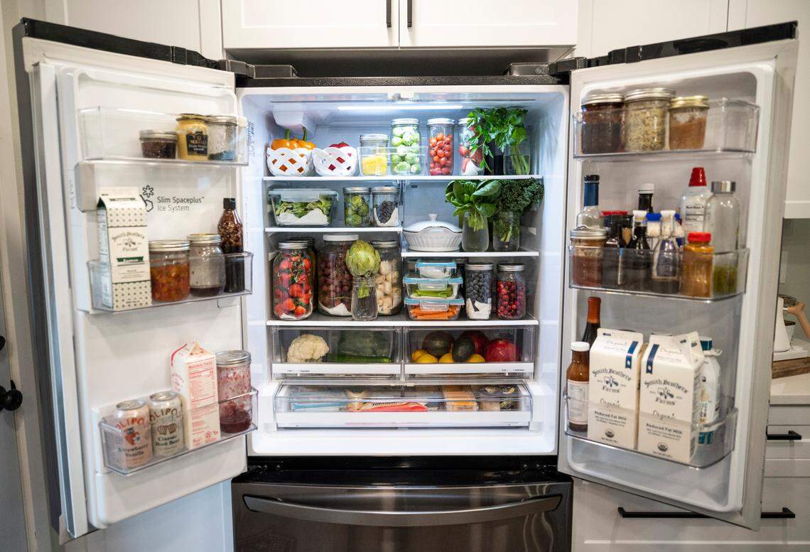A view of Amy Cross’s refrigerator where she stores produce that she has preserved for over three weeks at her home in Bonney Lake, Wash. on Dec. 7, 2022. Amy, the founder of The Cross Legacy, has amassed over 140,000 followers over the course of a year from sharing tips on social media platforms and her blog about how to preserve food and fresh produce to save money on groceries.