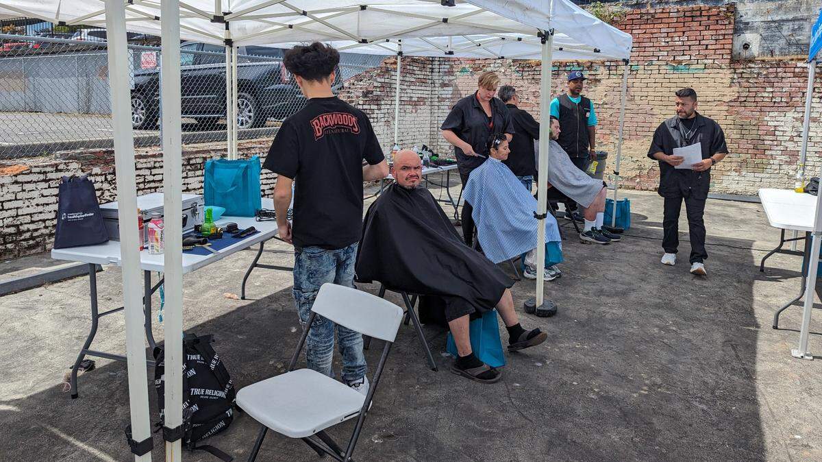 Attendees getting haircuts at former Beyond Boundaries event.