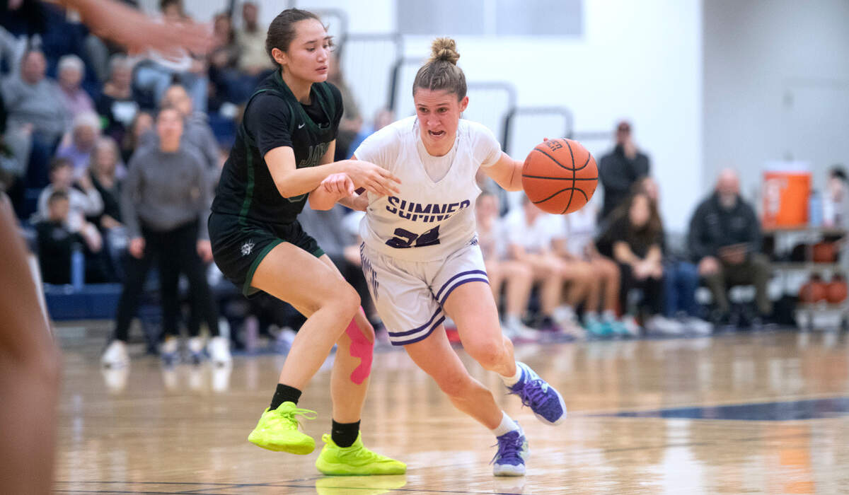 Sumner’s Lainee Houillon drives the lane against Emerald Ridge defender Naomi Senato during Saturday night’s 4A SPSL girls basketball tournament championship game at Tacoma Community College in Tacoma, Washington, on Feb. 4, 2023. Sumner held off a late Emerald Ridge rally to win the game, 50-48.
