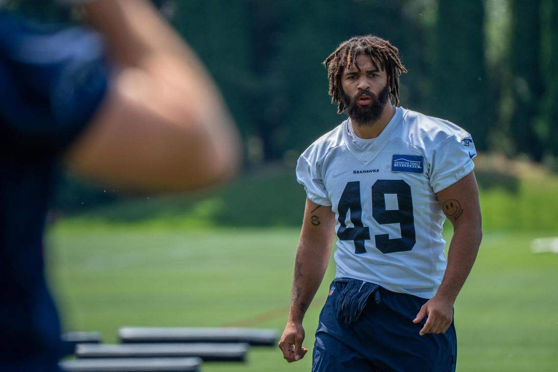 Seattle Seahawks linebacker Joshua Onujiogu gets in line for stretches during the first day of training camp at the Virginia Mason Athletic Center on July 27, 2022.