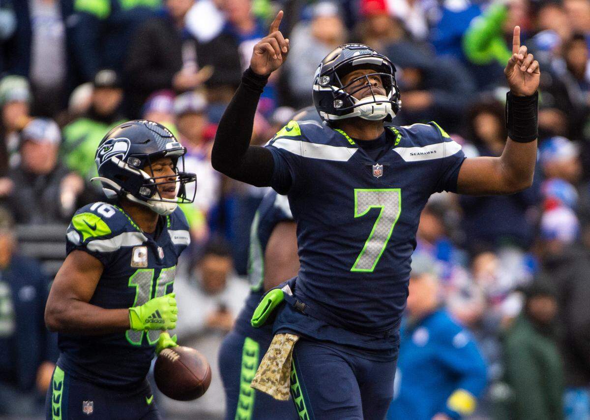Seattle Seahawks quarterback Geno Smith (7) points to the sky as he jogs off the field after passing the ball to Seattle Seahawks wide receiver Tyler Lockett (16) and scoring a touchdown in the fourth quarter of an NFL game at Lumen Field in Seattle, Wash. on Oct. 30, 2022. The Seahawks defeated the Giants 27-13.