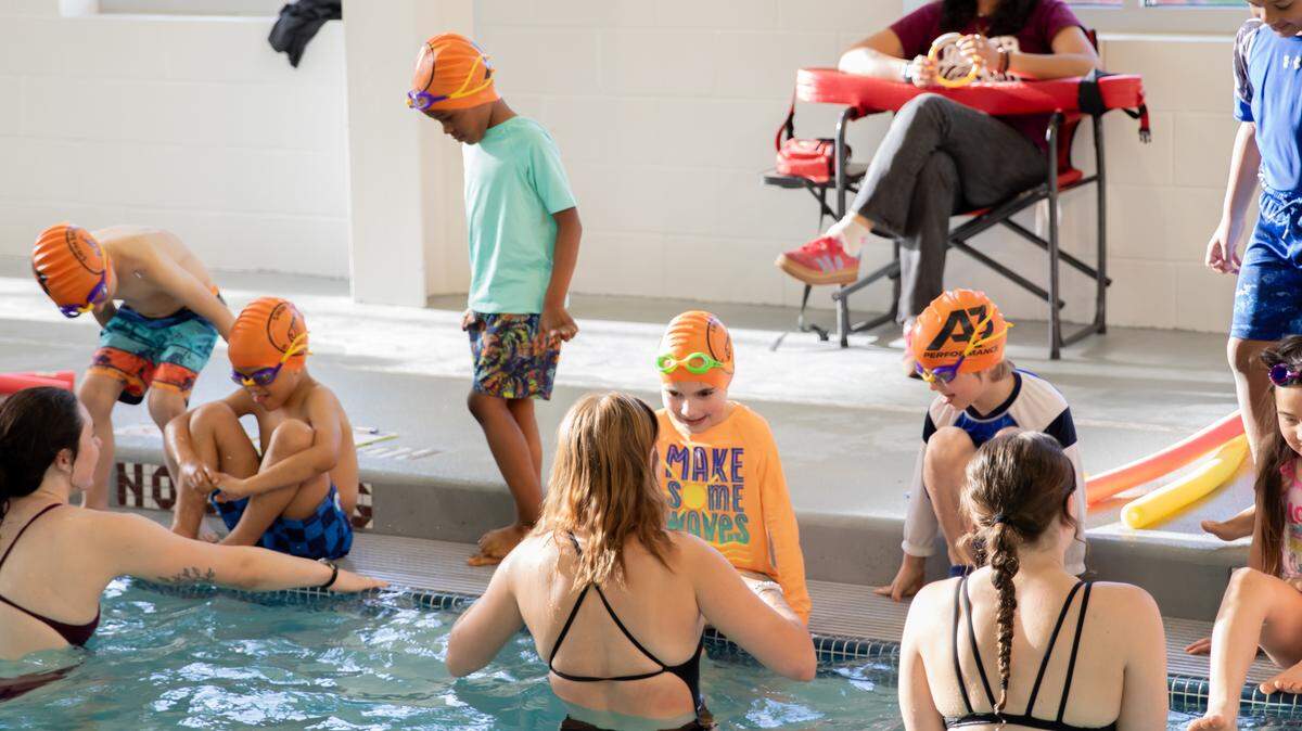 The University of Puget Sound’s swim team partnered with No More Under in 2025 to provide free swimming lessons for dozens of local children.