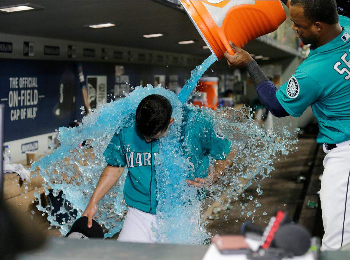 Seattle Mariners' Marco Gonzales is doused with ice by Jean Segura after pitching a six-hitter in the team's 4-1 win over the Kansas City Royals in a baseball game Friday, June 29, 2018, in Seattle. (AP Photo/John Froschauer)
