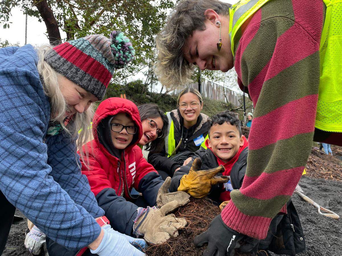 People gather for a South End Community Council-driven tree planting event earlier this year at South 72nd and D streets in Tacoma. Plantings like this one help bring more tree canopy cover to Tacoma’s neighborhoods.