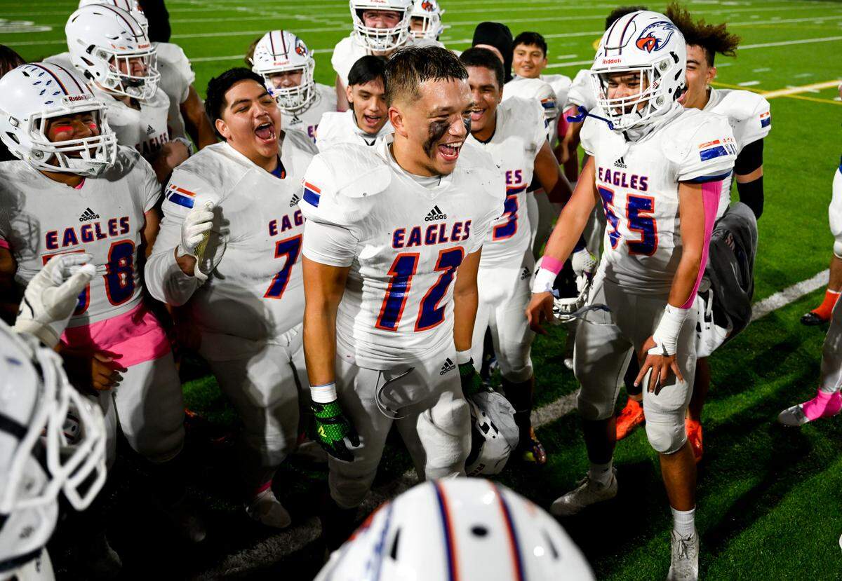 Graham-Kapowsin celebrates their 41-35 victory against Emerald Ridge at Sparks Stadium, Saturday, Oct. 21, 2023, in Puyallup, Wash.