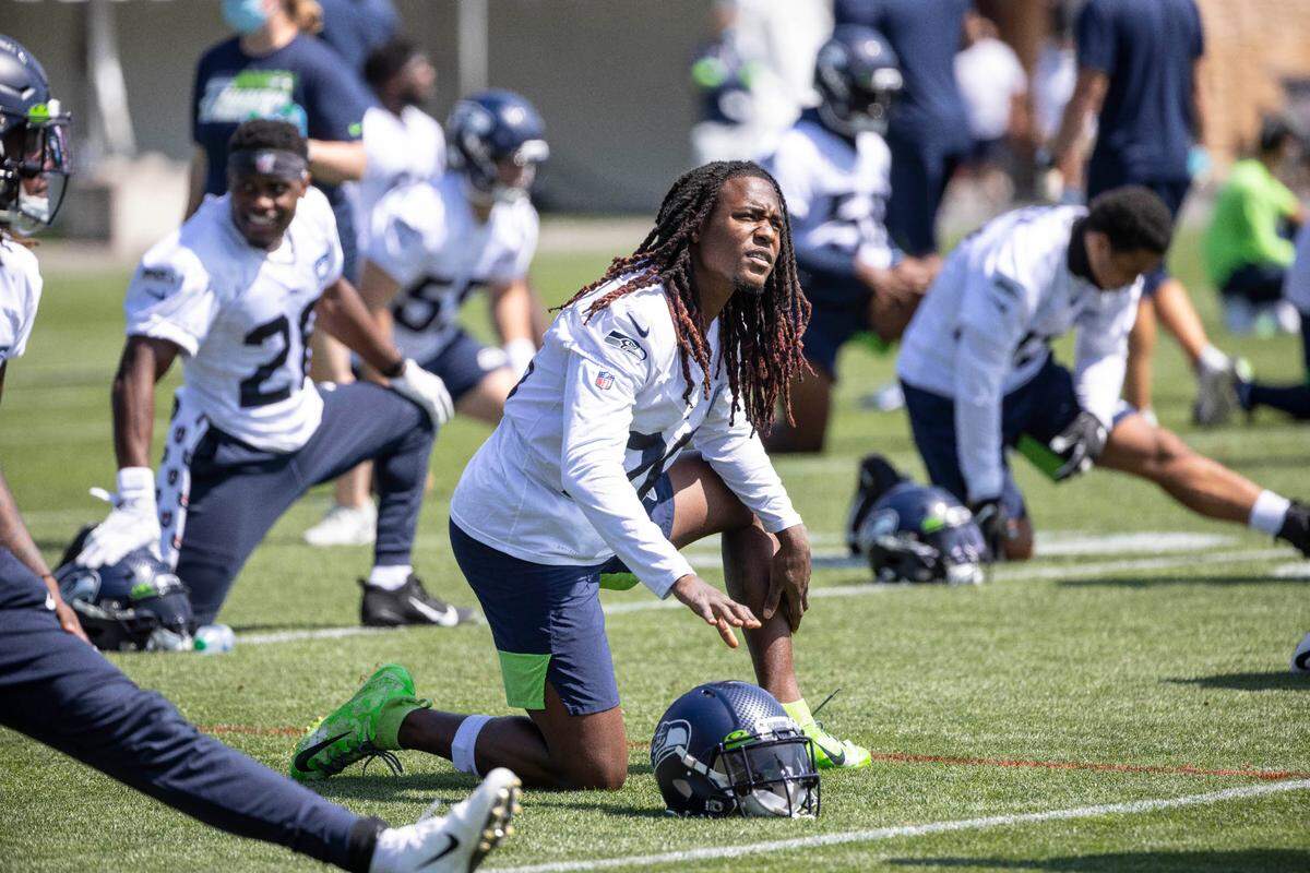 Shaquill Griffin, center, and his Seahawks teammates stretch at the start of Thursday’s workout. The Seattle Seahawks practiced Thursday, August 13, 2020 at the VMAC in Renton, WA.