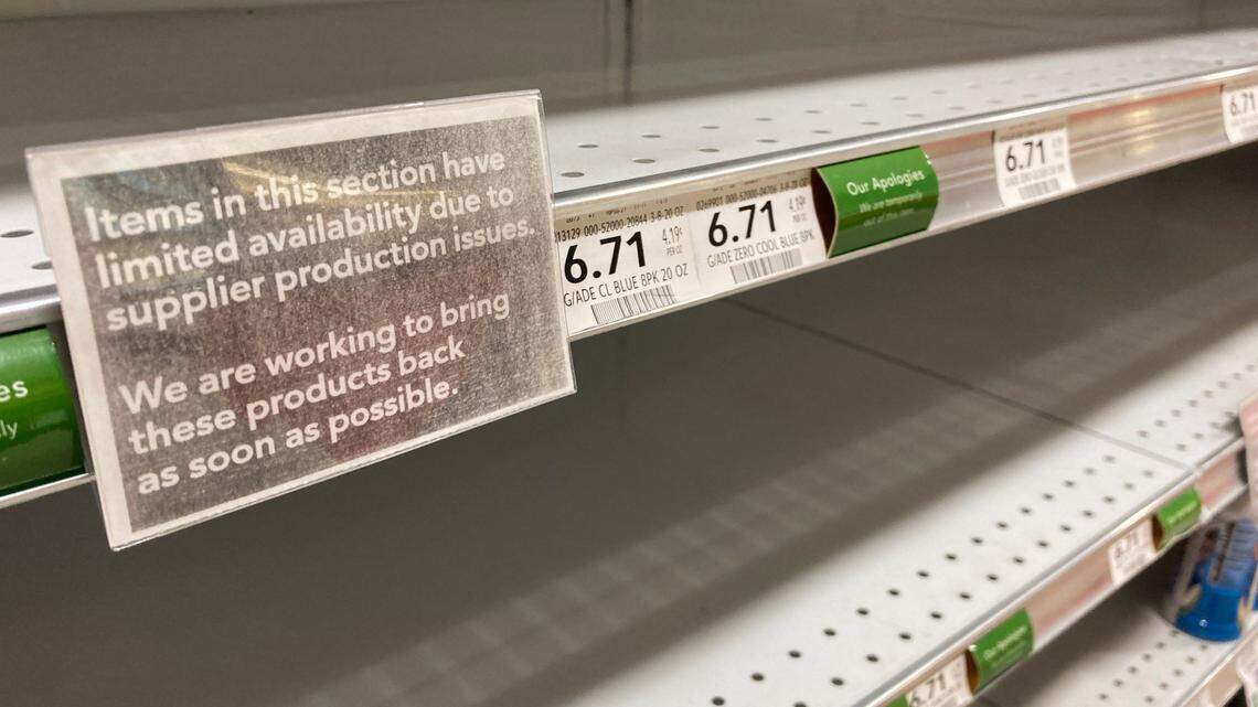 Shelves, empty “due to supplier production issues,” are shown in a grocery store, Wednesday, Dec. 15, 2021, in Surfside, Florida.