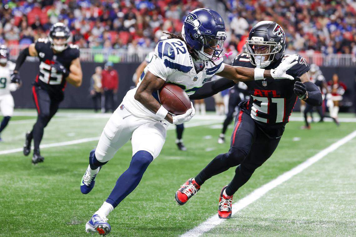 Rashid Shaheed (22) of the Seattle Seahawks runs the ball against Mike Hughes (21) of the Atlanta Falcons during the first quarter at Mercedes-Benz Stadium on Dec. 7, 2025 in Atlanta.