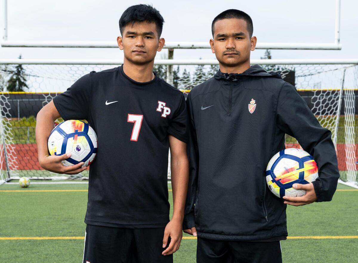 Franklin Pierce High School sophomore twin brothers Preston Soeum, left, and Marvin Soeum pose for a portrait on the soccer field at Franklin Pierce High School in Tacoma, Wash. on Monday, April 11, 2022. The brothers have the Cardinals sitting in first place in the 2A SPSL.