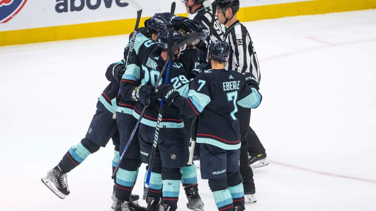 Seattle Kraken players celebrate with Seattle Kraken defenseman Adam Larsson (6) after he scored the Kraken’s third goal during the third period of game four of the second round of the 2023 Stanley Cup Playoffs in Seattle, Wash. on May 9, 2023. The Kraken lost 3-6 to the Dallas Stars.