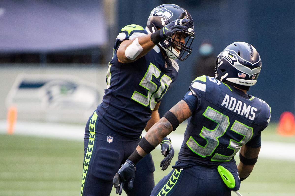 Seattle Seahawks linebacker K.J. Wright and Seattle Seahawks defensive back Jamal Adams celebrate a Jets fumble. The Seattle Seahawks played the New York Jets in a NFL football game at Lumen Field in Seattle, Wash., on Sunday, Dec. 13, 2020.