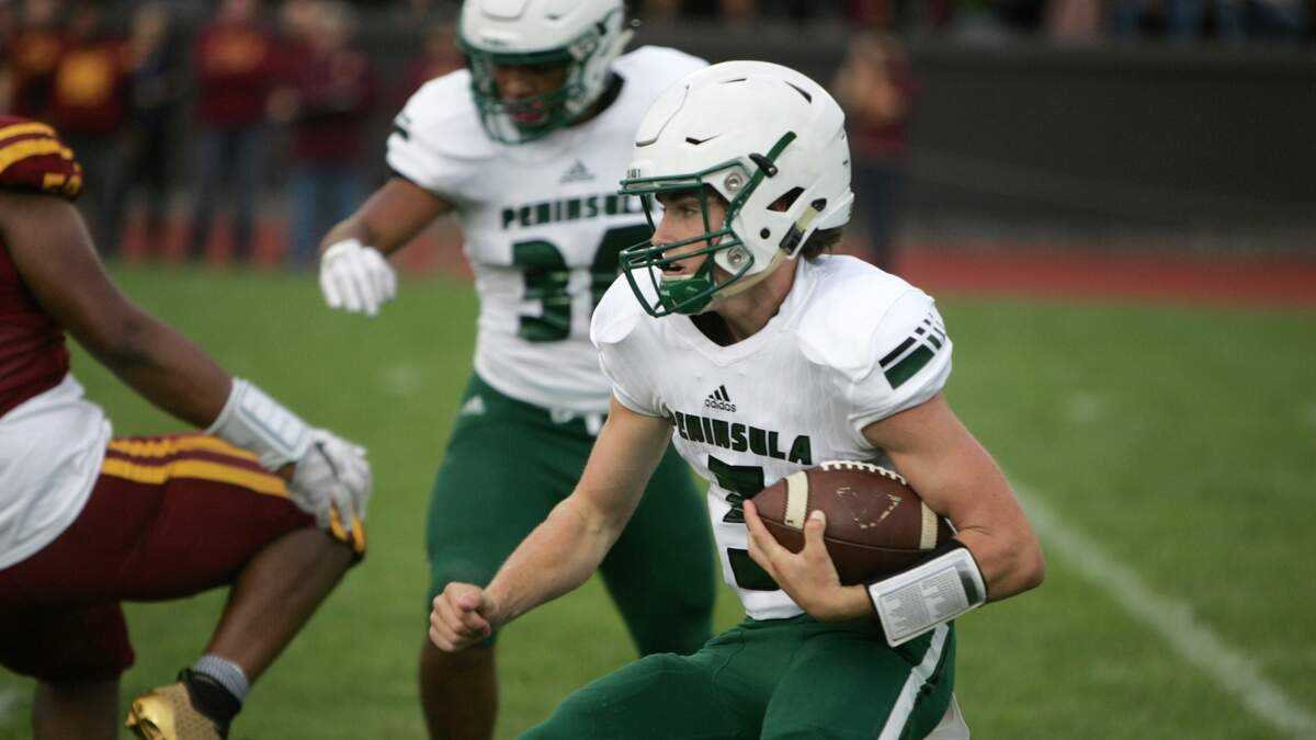 Peninsula High School senior quarterback Burke Griffin rushes against O’Dea at West Seattle Stadium on Friday, Aug. 31. O’Dea won the season opener, 28-0.