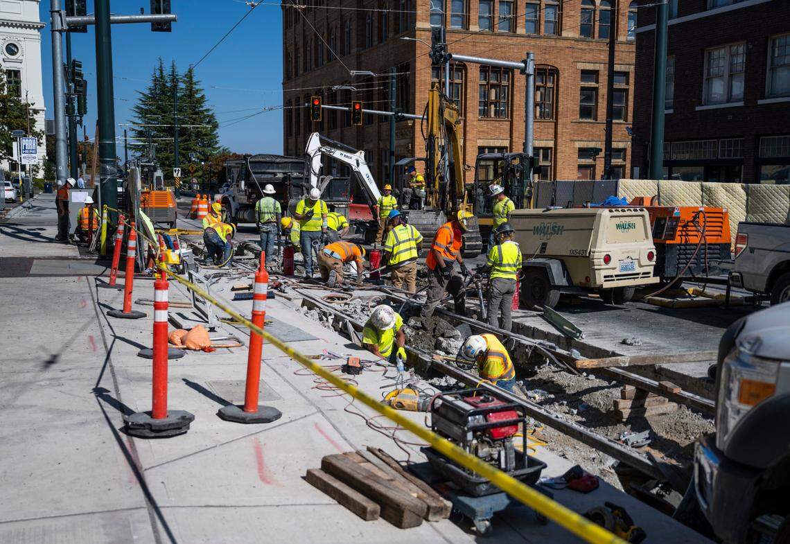 Construction crews work on a project to connect the Hilltop Link Extension to Tacoma Link on South 7th and Commerce streets in downtown Tacoma, Wash. on Sept. 20, 2022.