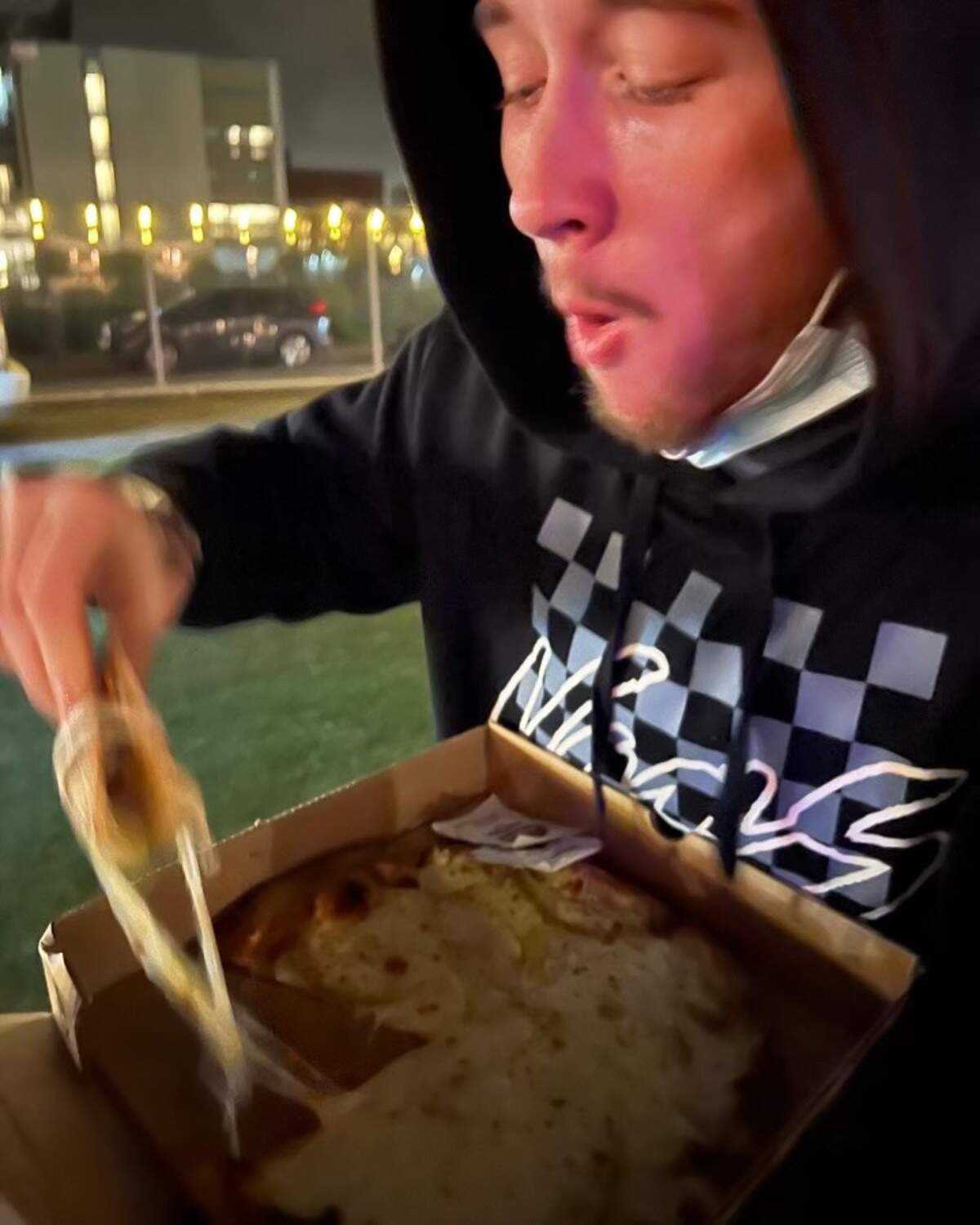 Samuel Ranz eats pizza in San Francisco on his honeymoon road trip in December 2021.