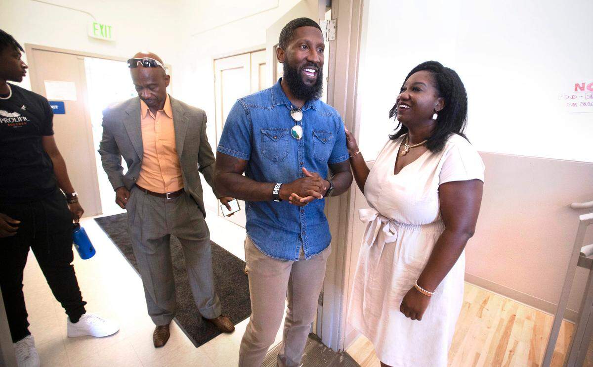 Monica C. Mathewst, founder and CEO of Life Enrichment Group, greets former Seattle Seahawk Marcus Trufant, who grew up in Tacoma, to the public tour of the new expanded homeless youth services at the Beacon Center in Tacoma on Wednesday, July 20, 2022.