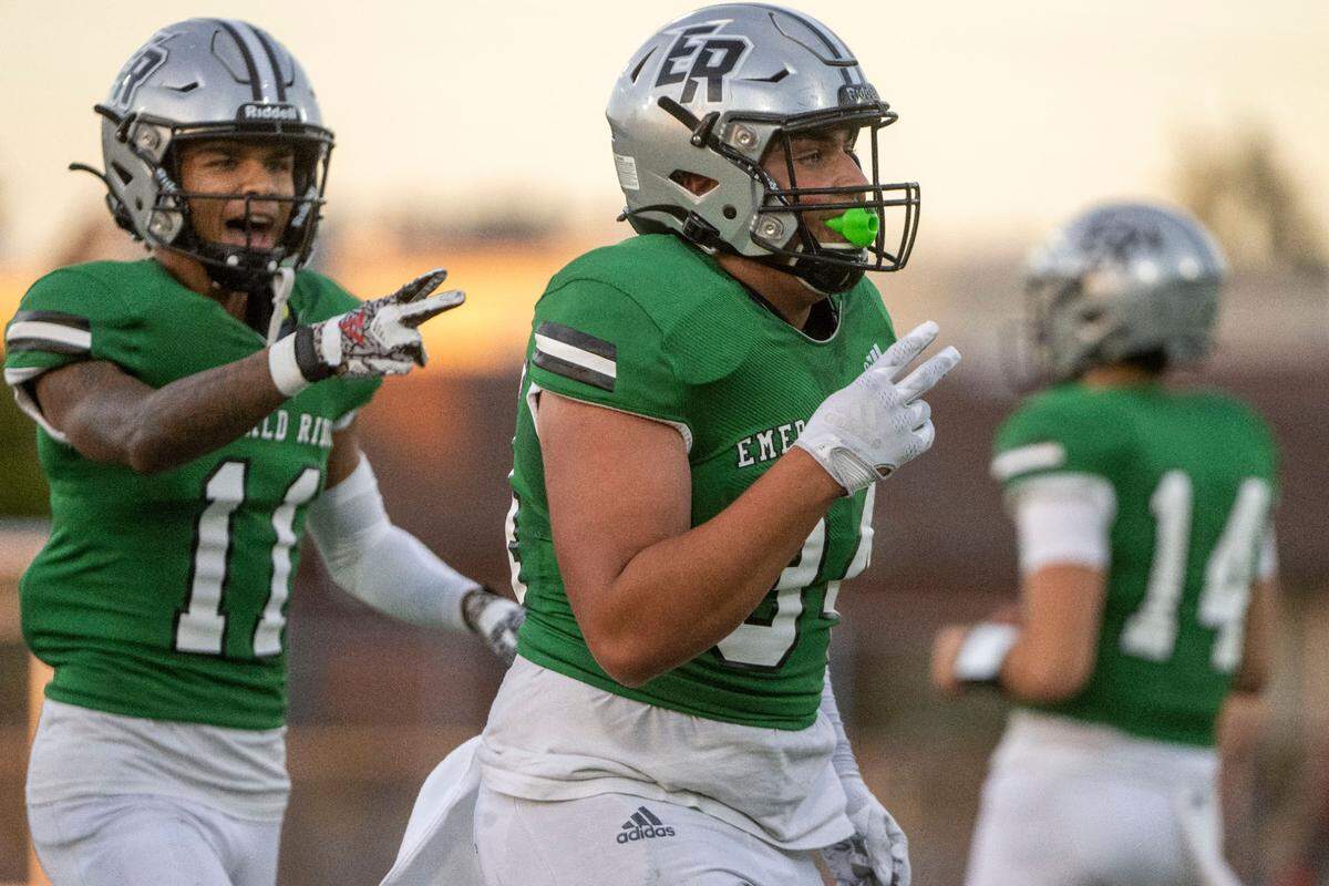 Emerald Ridge linebacker Dylan Mathews celebrates by holding up two fingers indicating his second interception of the game during the first quarter of a 4A SPSL game against Olympia at Sparks Stadium on Thursday, Sept. 8, 2022, in Puyallup, Wash.