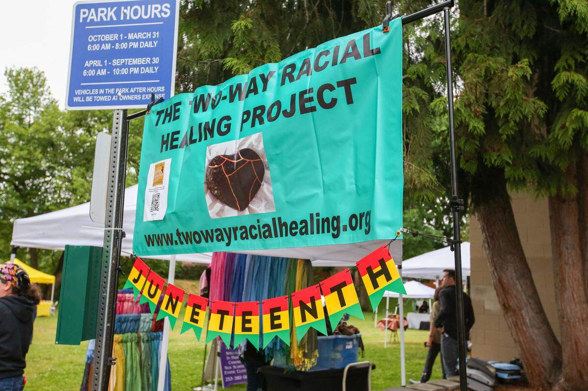 A group of community members in Puyallup celebrated Juneteenth on Saturday, June 10, 2023 at Grayland Park. Vendors sold lemonade, cakes, cookies and vegan food. Music played in the background as people danced and spoke with each other. There was a bouncy house.