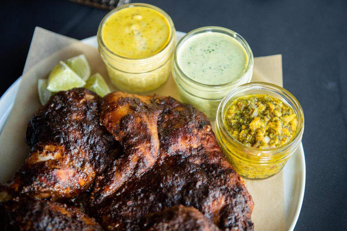The Bird at Spice Lab inside Harmon Brewing in Tacoma, Wash., on Friday, Jan. 29, 2021. The Bird, a whole chicken grilled in the Peruvian style, is served with smashed potatoes and three sauces for $20.