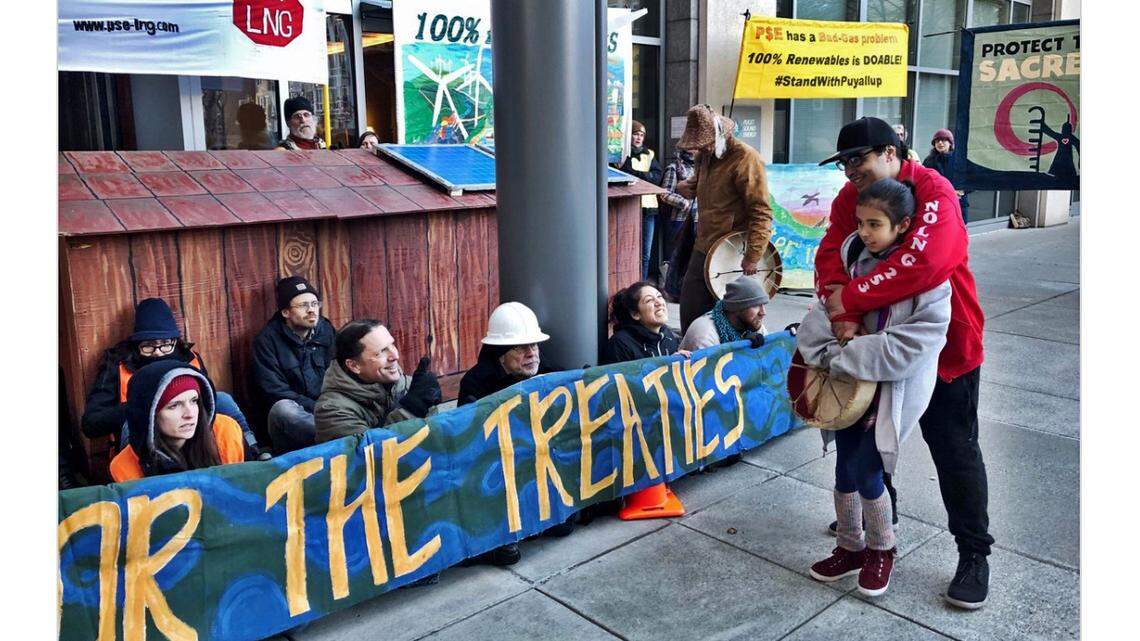 A photo posted on Twitter from the protest at Puget Sound Energy's headquarters Monday morning shows the small replica of a Native American longhouse in front of the company's Bellevue office.