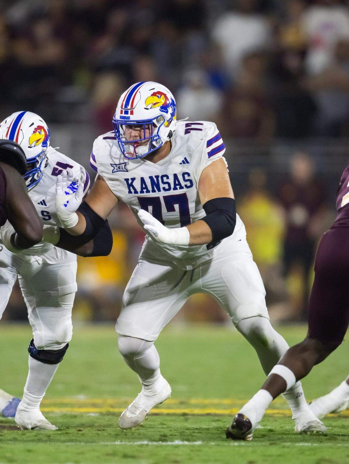Oct 5, 2024; Tempe, Arizona, USA; Kansas Jayhawks offensive lineman Bryce Cabeldue (77) against the Arizona State Sun Devils at Mountain America Stadium. Mandatory Credit: Mark J. Rebilas-Imagn Images