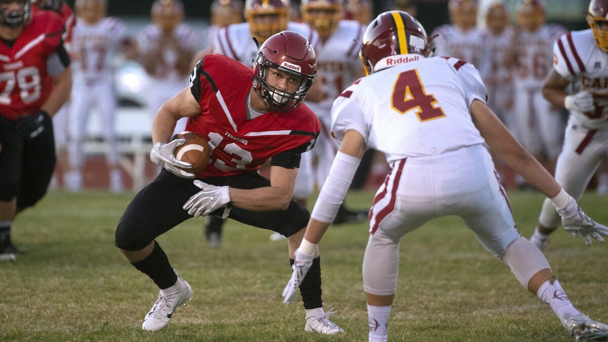 Yelm running back Kodee Gifford looks to evade Capital defensive back Chad Garland during Friday night’s football game at Yelm High School on Sept. 28, 2018.