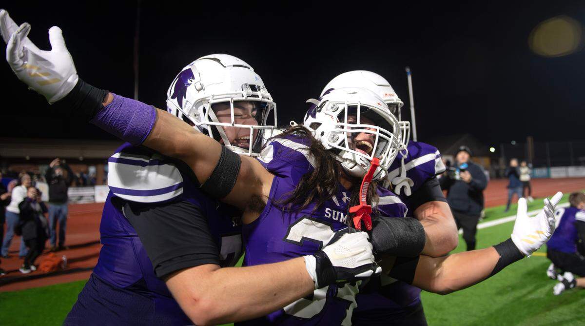 Sumner’s Kameron Raboteau (left) celebrates with running back Steele Isaacs after the Spartans 37-31 triple overtime victory over the Chiawana Riverhawks in Saturday’s 4A state football semifinal game at Sunset Chev Stadium in Sumner, Washington, on Nov. 30, 2024. Sumner advances to next weekend’s state championship game at Husky Stadium in Seattle.