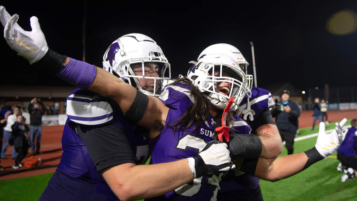 Sumner’s Kameron Raboteau (left) celebrates with running back Steele Isaacs after the Spartans 37-31 triple overtime victory over the Chiawana Riverhawks in Saturday’s 4A state football semifinal game at Sunset Chev Stadium in Sumner, Washington, on Nov. 30, 2024. Sumner advances to next weekend’s state championship game at Husky Stadium in Seattle.