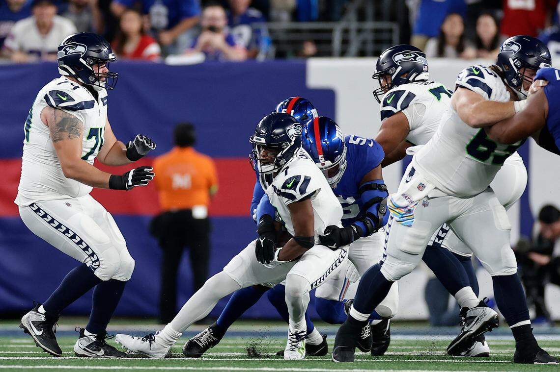 Seattle Seahawks quarterback Geno Smith (7) is sacked by New York Giants linebacker Azeez Ojulari (51) during the first quarter of an NFL football game, Monday, Oct. 2, 2023, in East Rutherford, N.J. (AP Photo/Adam Hunger)