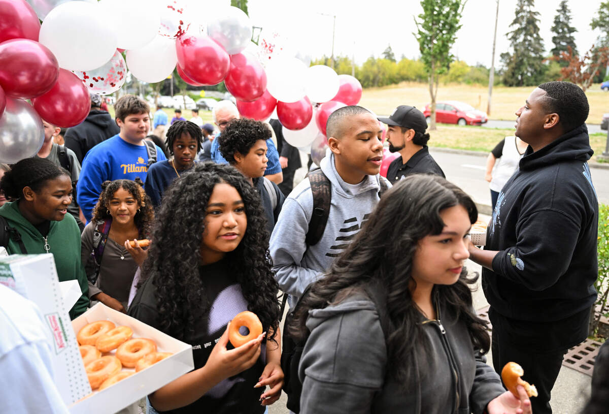 Students funnel in with doughnuts in hand on the first day of school at Gray Middle School, on Monday, Sept. 9, 2024, in Tacoma.