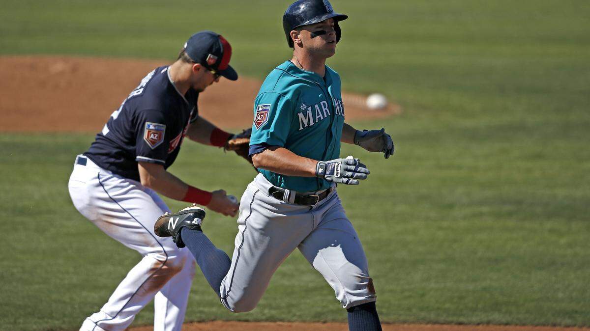 Cleveland Indians' Richie Shaffer, left, makes a catch at first base beating Seattle Mariners' John Andreoli (57) to the bag during the fourth inning of a spring training baseball game Wednesday, Feb. 28, 2018, in Goodyear, Ariz. The Indians defeated the Mariners 4-2. (AP Photo/Ross D. Franklin)