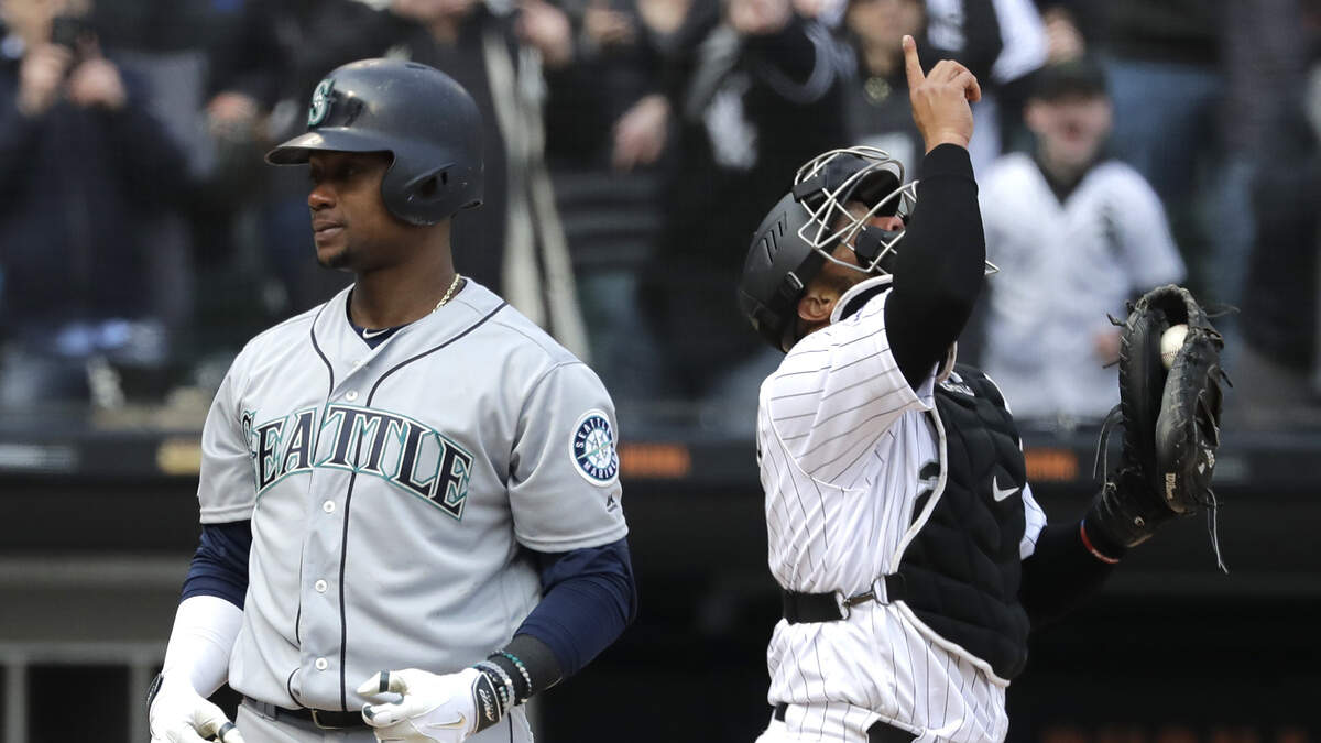 Seattle Mariners’ Tim Beckham, left, reacts after being called out on strikes to end the baseball game, as Chicago White Sox catcher Welington Castillo celebrates Friday, April 5, 2019, in Chicago. The White Sox won 10-8. (AP Photo/Nam Y. Huh)