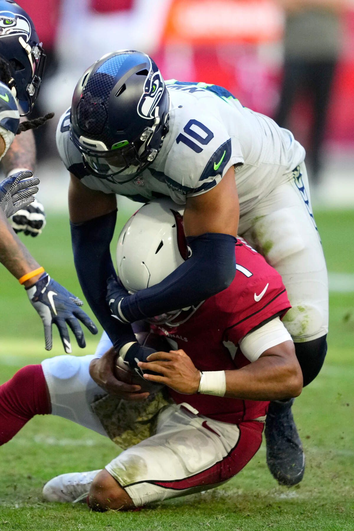 Seattle Seahawks linebacker Uchenna Nwosu (10) sacks Arizona Cardinals quarterback Kyler Murray (1) during the second half of an NFL football game in Glendale, Ariz., Sunday, Nov. 6, 2022. (AP Photo/Matt York)