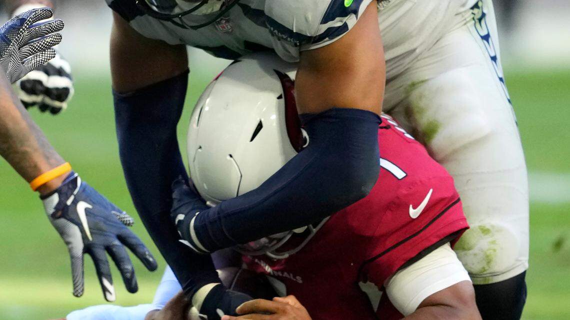 Seattle Seahawks linebacker Uchenna Nwosu (10) sacks Arizona Cardinals quarterback Kyler Murray (1) during the second half of an NFL football game in Glendale, Ariz., Sunday, Nov. 6, 2022. (AP Photo/Matt York)