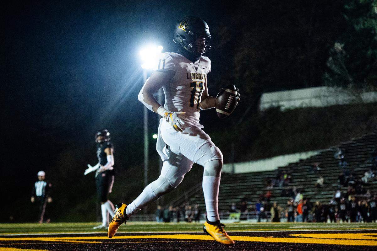 Lincoln’s Jasiah Snow-Marshall runs in a touchdown after a catch during the first quarter. Lincoln played Bethel in a a football game at the Lincoln Bowl in Tacoma, Wash., on Friday, Nov. 1, 2019.