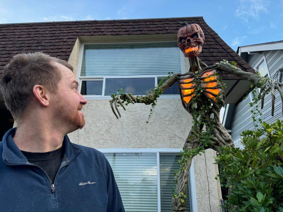 Kyle Rinner has two gigantic skeletons outside his Titlow Beach area home. This one, a 12-foot-tall “Inferno” model features a pumpkin head.