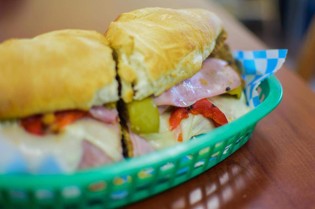Sur Bakery makes Argentinian pastries and sandwiches at 10518 South Tacoma Way in Lakewood, Wash. Served on housemade French bread, the sandwich de milanesa features breaded steak and ham with cheese, red peppers, green olives, mayo and chimichurri.