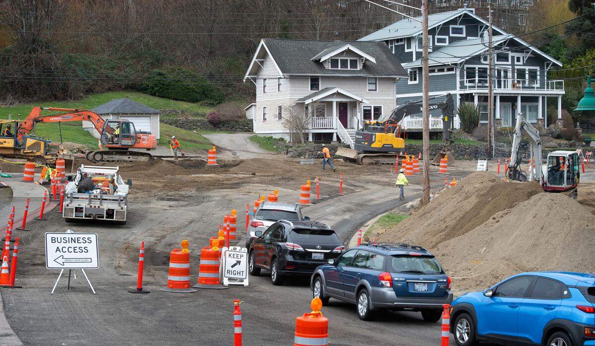 One-way traffic flows northbound through the roundabout construction project at Harborview Drive and Stinson Avenue along the downtown waterfront in Gig Harbor, Washington, on Friday, March 11, 2022. Southbound traffic faces a seven-mile detour route around the site.