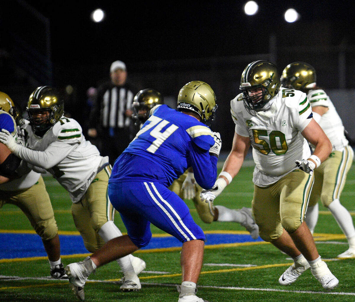 Evergreen’s Fox Crader (50) gets ready to make a block against Kelso’s Payton Stewart (74) during a 3A GSHL game on Friday, Oct. 27, 2023, at Kelso High School. (Will Denner/The Columbian)