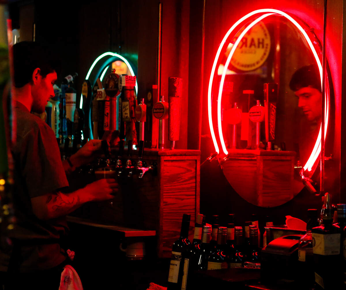 A bartender at The Spar pours a beer while the Twang Junkies play Aug. 10, 2019. The Spar is the oldest tavern in Tacoma.