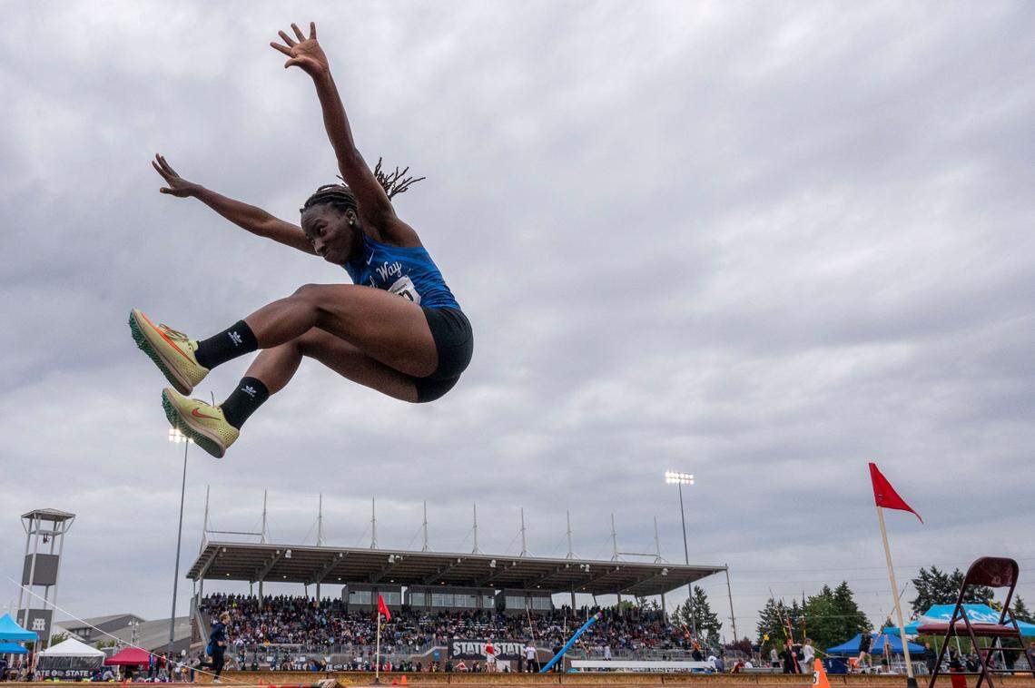 Federal Way’s Esther Akinlosotu flies through the air during her second triple jump attempt in the 4A finals at the State 2A, 3A, 4A track and field championships on Thursday, May 26, 2022, at Mount Tahoma High School in Tacoma Wash. Akinlosotu finished in second place with a jump of 38.25 feet.