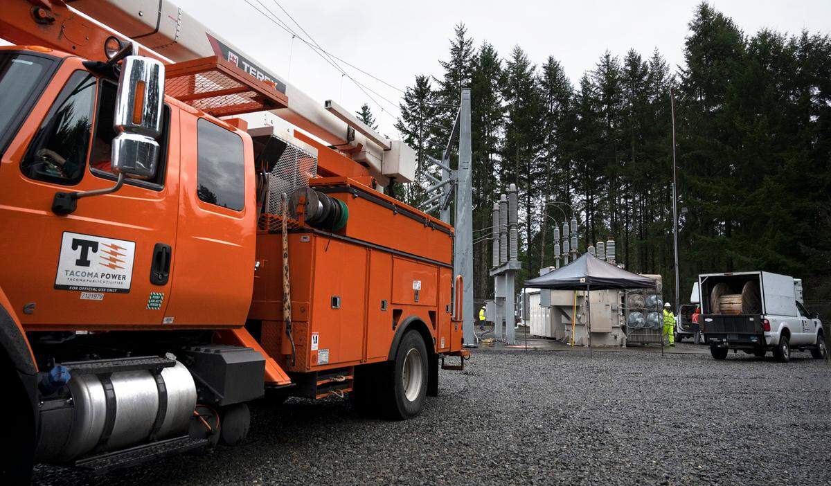 Tacoma Public Utilities workers switch the 224th Street East substation to a mobile transformer to restore power in Graham, Washington, on Monday, Dec. 26, 2022.