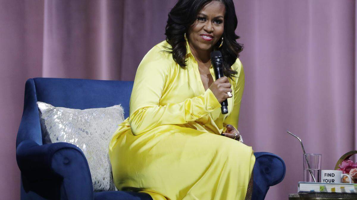 Former first lady Michelle Obama responds to questions as she is interviewed by actress Sarah Jessica Parker during an appearance for her book, “Becoming” at Barclays Center in New York last year. A stagehand union is set to demonstrate at her Tacoma Dome event Sunday.