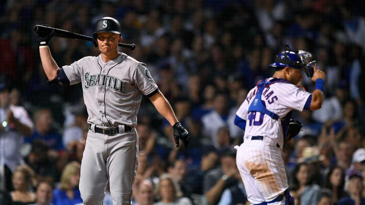 Seattle Mariners’ Kyle Seager left, reacts after striking out while Chicago Cubs catcher Willson Contreras right, walks off the field during the seventh inning of a baseball game Tuesday, Sept. 3, 2019, in Chicago.