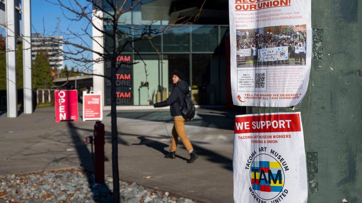 Flyers in support of the Tacoma Art Museum’s union are hung on a streetlight pole outside the museum on Friday, Dec. 16, 2022, in Tacoma, Wash.