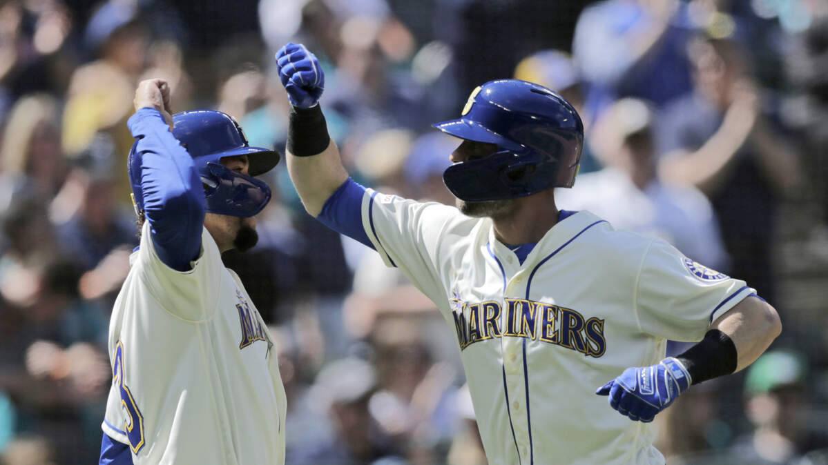 Seattle Mariners’ J.P. Crawford, left greets Mitch Haniger after scoring on Haniger’s two-run home run on a pitch from Minnesota Twins’ Kyle Gibson during the fifth inning of a baseball game, Sunday, May 19, 2019, in Seattle.