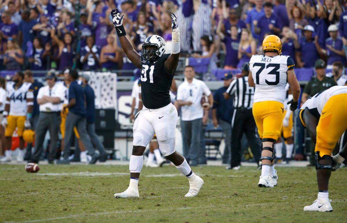 TCU defensive tackle L.J. Collier (91) celebrates as TCU plays West Virginia late in the fourth quarter of an NCAA college football game Saturday, Oct. 7, 2017, in Fort Worth, Texas. TCU won 31-24. (AP Photo/Ron Jenkins)