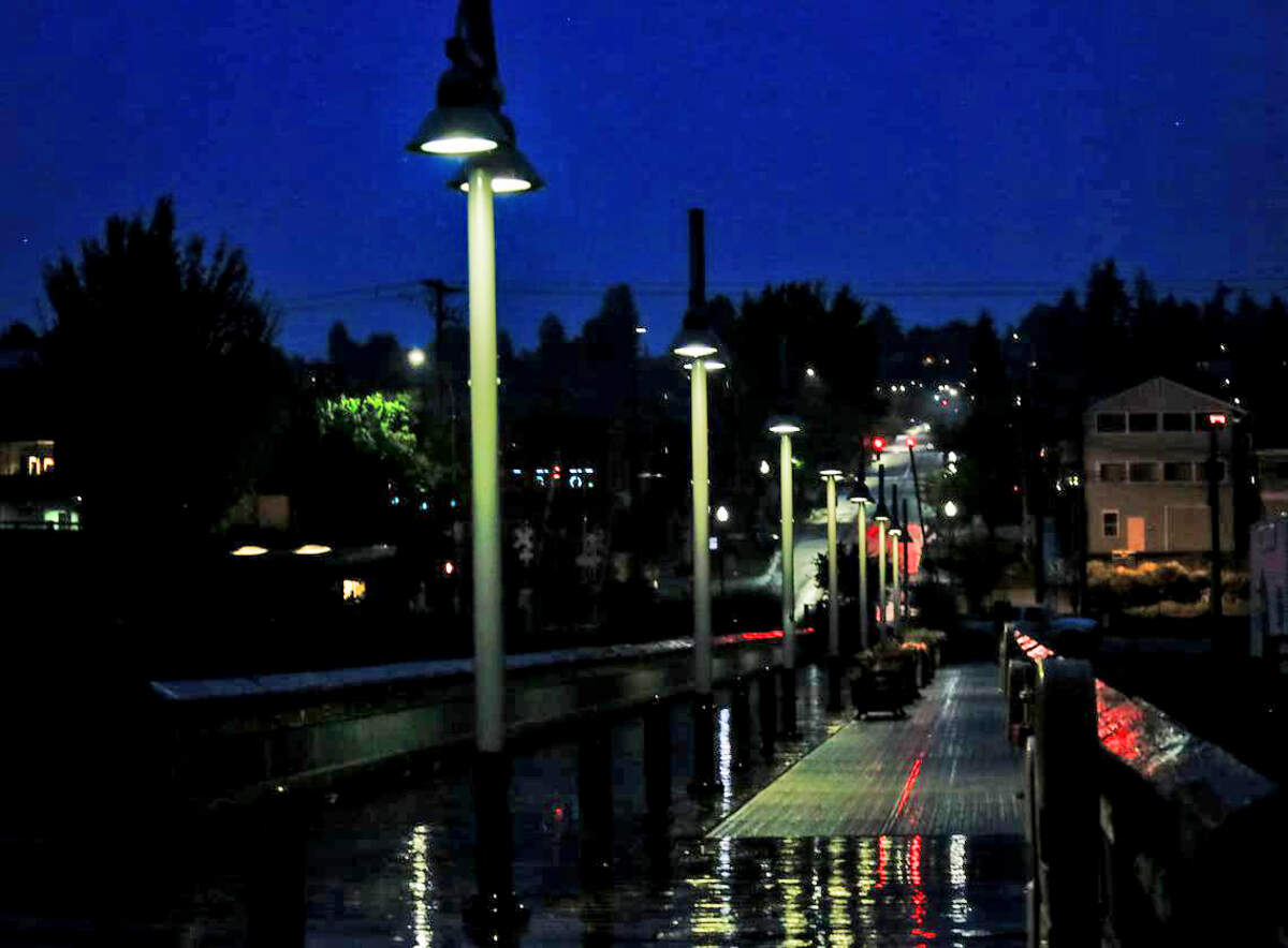 Light shines off the water on the dock in Old Town Tacoma Aug. 10, 2019.