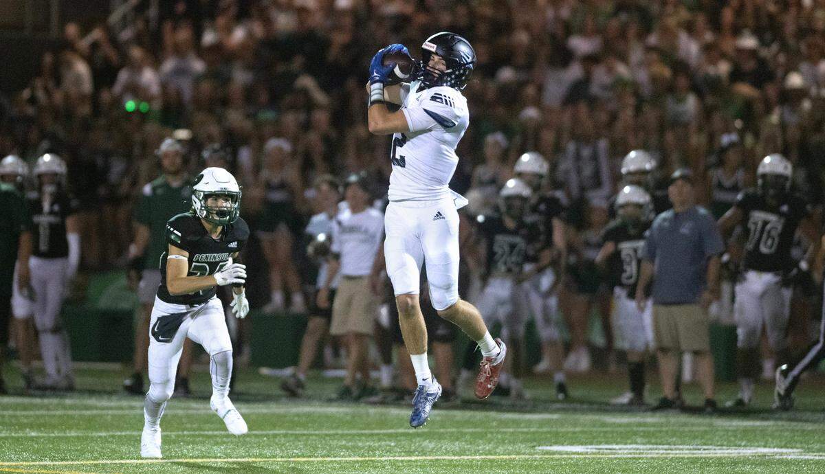 Gig Harbor wide receiver Drake Matthies pulls in a pass during Friday night’s Fish Bowl crosstown rivalry football game against the Peninsula Seahawks at Roy Anderson Field in Purdy, Washington, on Sept. 15, 2023. Gig Harbor won the game, 21-20.