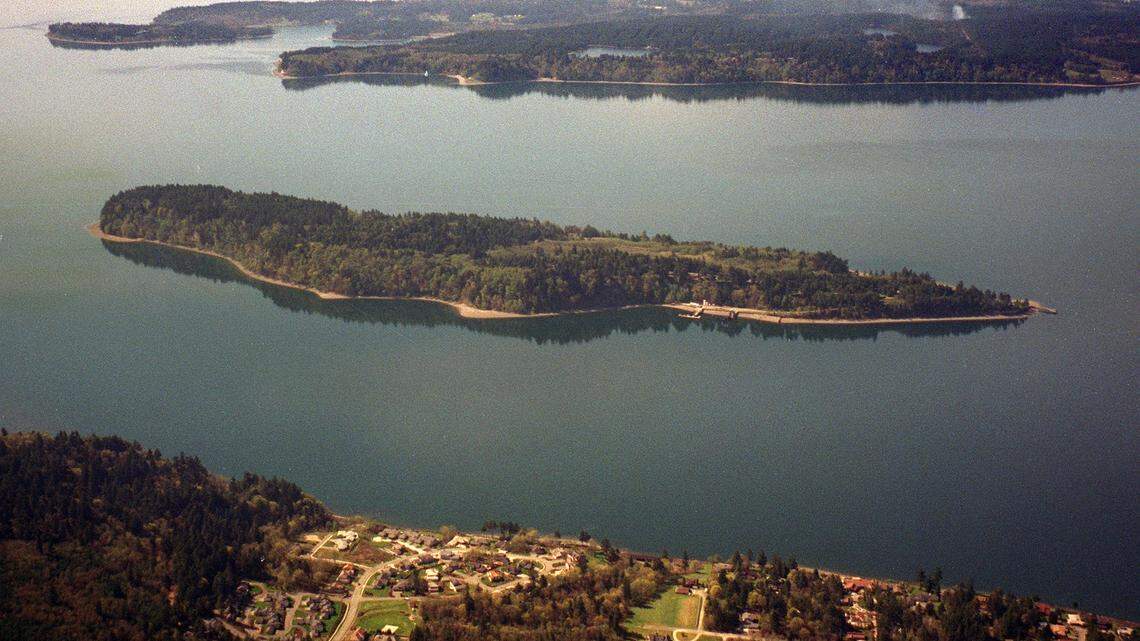 Ketron Island sits in Puget Sound, with Anderson Island in the background and in the foreground is the town of Steilacoom in this undated file photo.