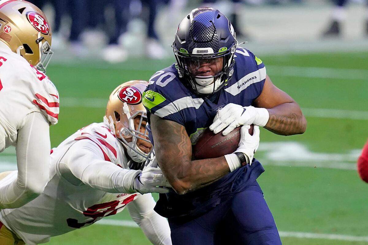 Seattle Seahawks running back Rashaad Penny (20) runs as San Francisco 49ers defensive end Arik Armstead defends during the second half of an NFL football game, Sunday, Jan. 3, 2021, in Glendale, Ariz. (AP Photo/Ross D. Franklin)